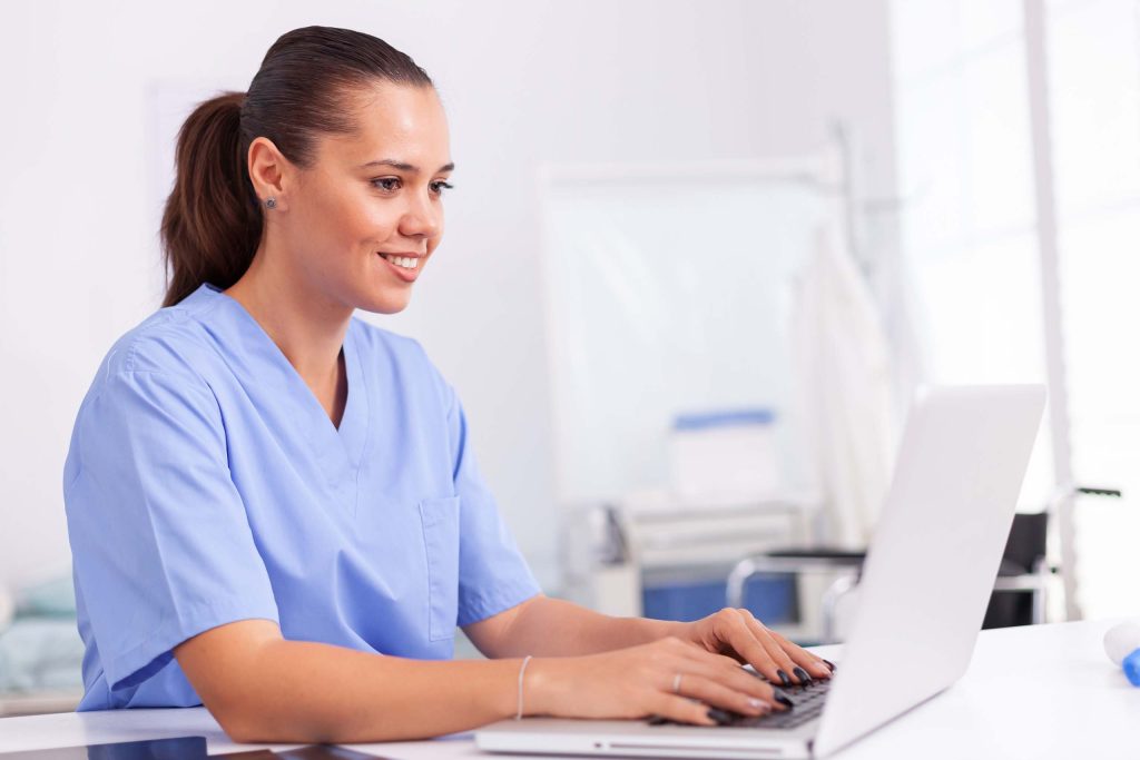 Nurse typing on computer